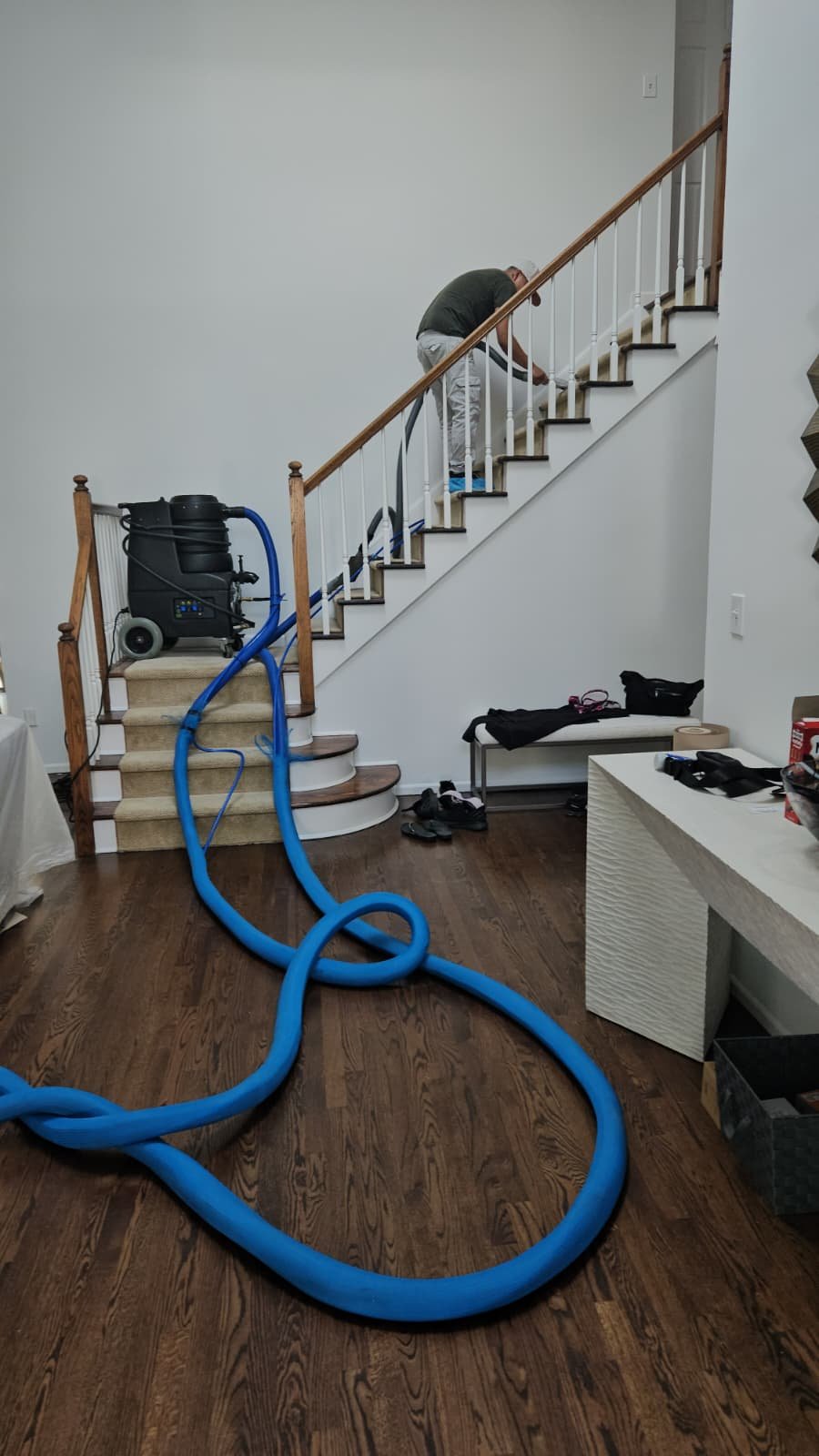 Carpet cleaning hose run up the stairs of a Manhattan walk-up apartment